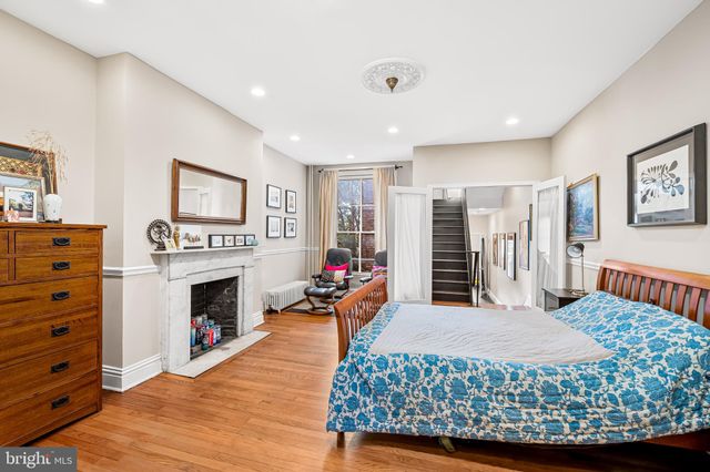 a bedroom with filled bed and a window