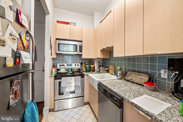 a kitchen with a stove and a white cabinets