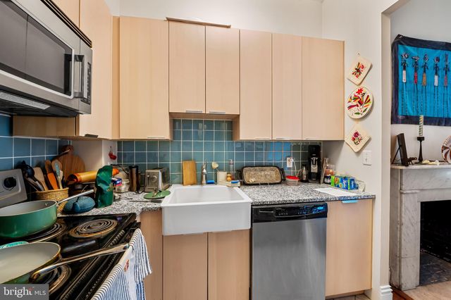 a bathroom with a sink a toilet and shower curtain