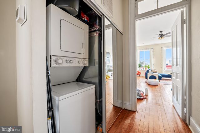 a living room with furniture a clock and a fireplace