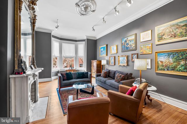 a living room with furniture or couch and a chandelier