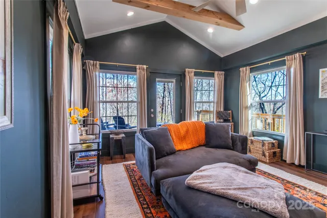 a bedroom with furniture and a potted plant