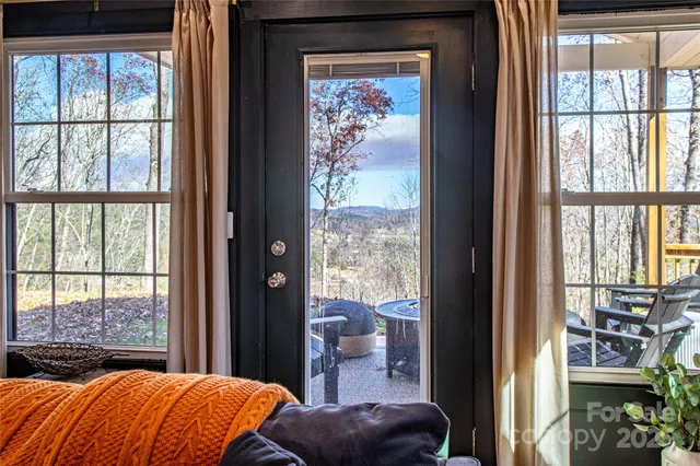 a bedroom with a large window and a bed