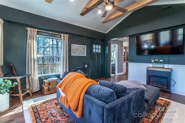 a living room with furniture and a flat screen tv