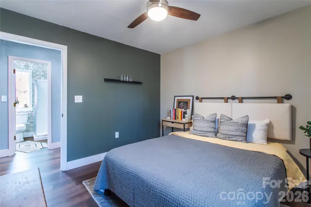 a bedroom with a bed and table