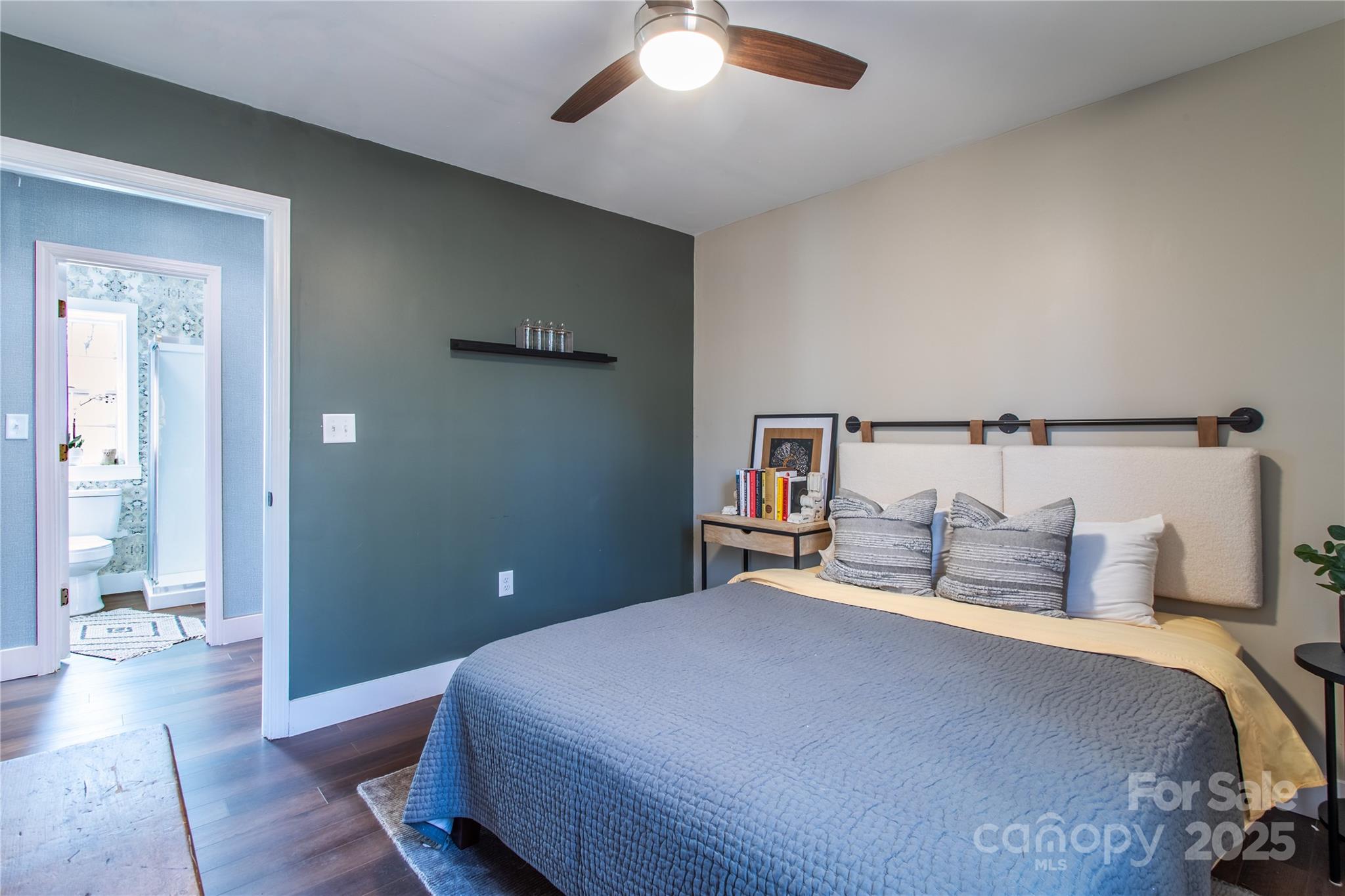 426-428 Weaver Creek Road Brevard, NC 28712 - Photo 22 of 48 a bedroom with a bed and painting on the wall