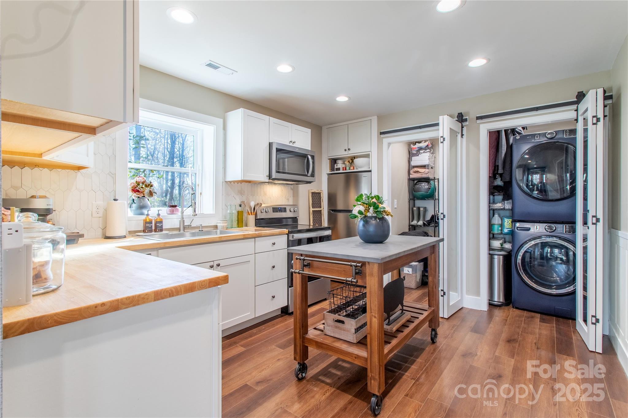 426-428 Weaver Creek Road Brevard, NC 28712 - Photo 24 of 48 a kitchen with stainless steel appliances granite countertop a sink and cabinets