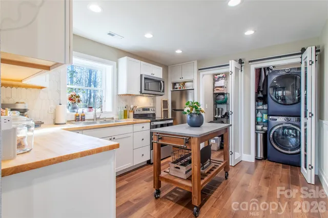 a kitchen with stainless steel appliances granite countertop a sink and cabinets