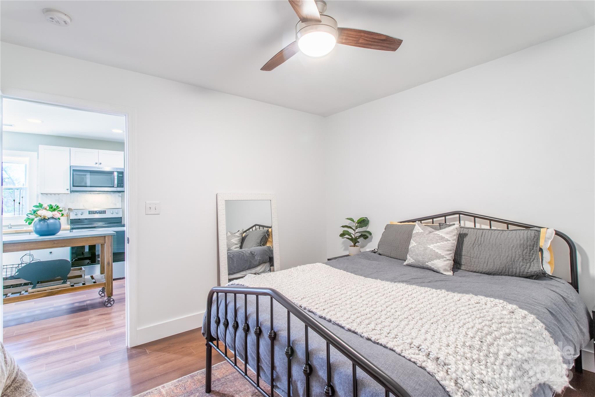 426-428 Weaver Creek Road Brevard, NC 28712 - Photo 28 of 48 a bedroom with a bed and wooden floor