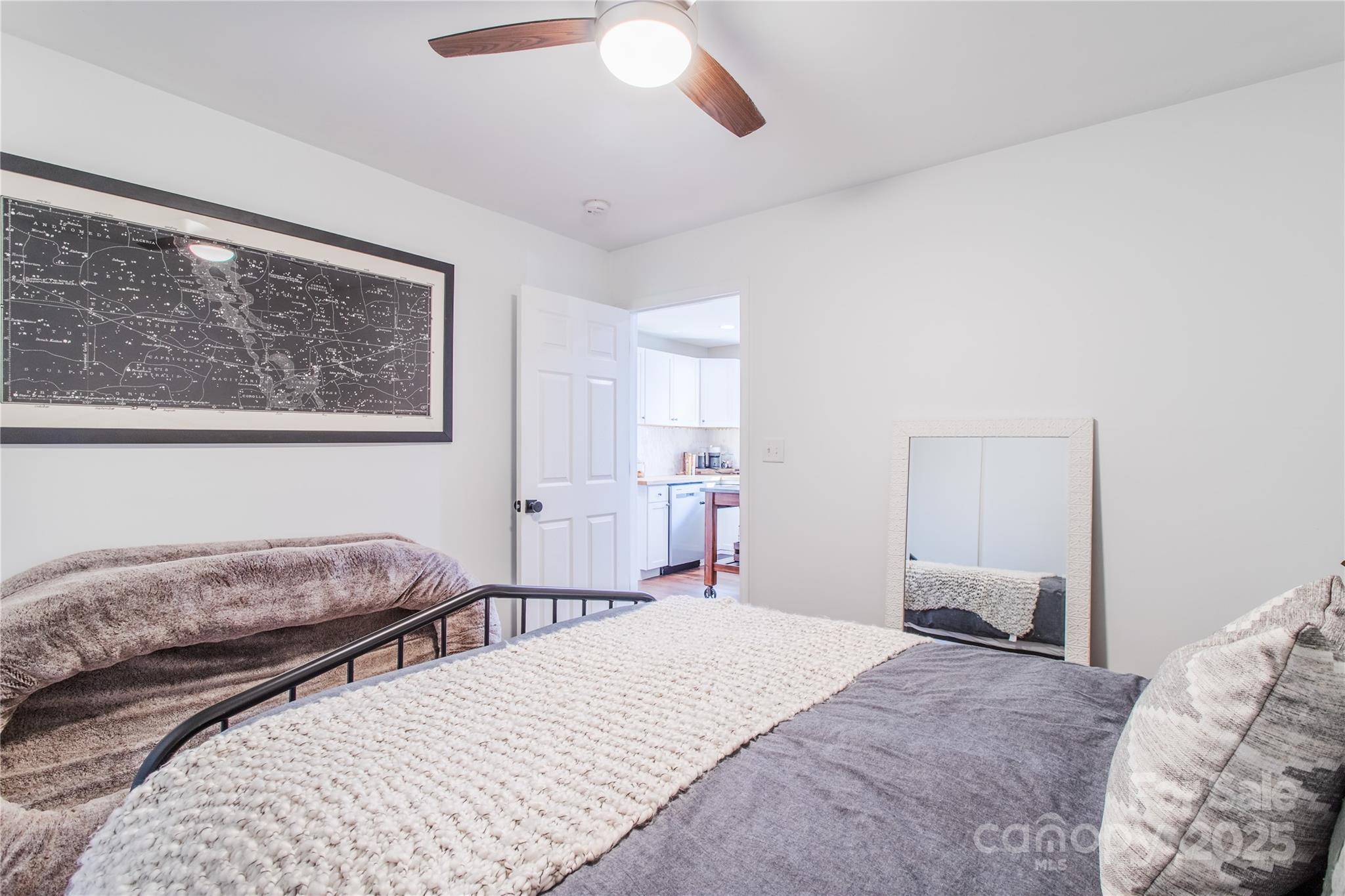 426-428 Weaver Creek Road Brevard, NC 28712 - Photo 29 of 48 a bedroom with a large bed and a chandelier