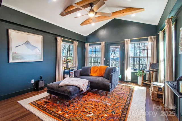 a living room with furniture ceiling fan and a rug