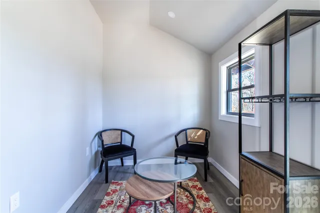 a view of a room with a table and chairs