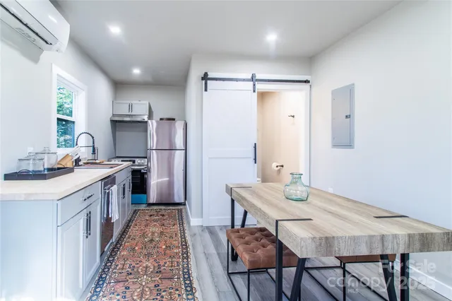 a kitchen with granite countertop a sink appliances and cabinets
