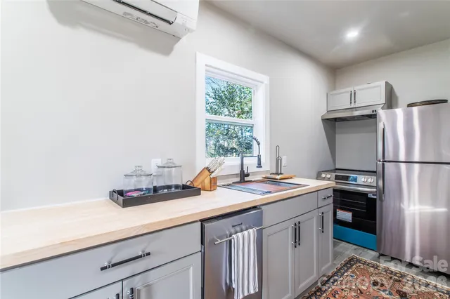 a kitchen with refrigerator cabinets and wooden floor