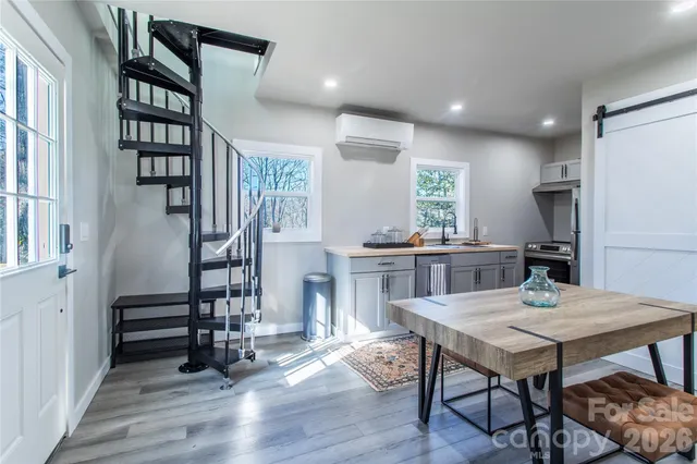 a view of a dining room with furniture and wooden floor