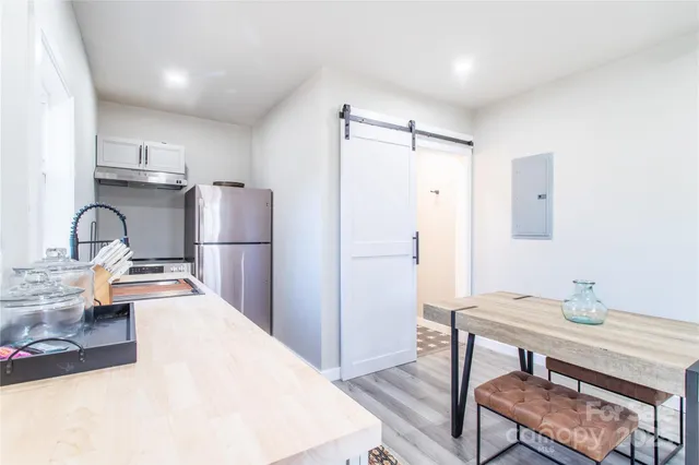 a kitchen with refrigerator cabinets and wooden floor