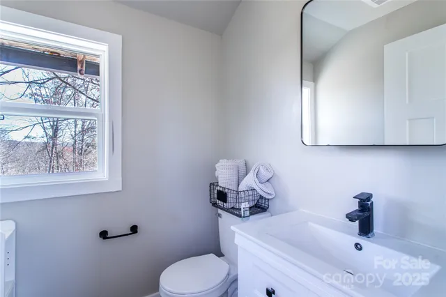 a bathroom with a sink mirror and toilet