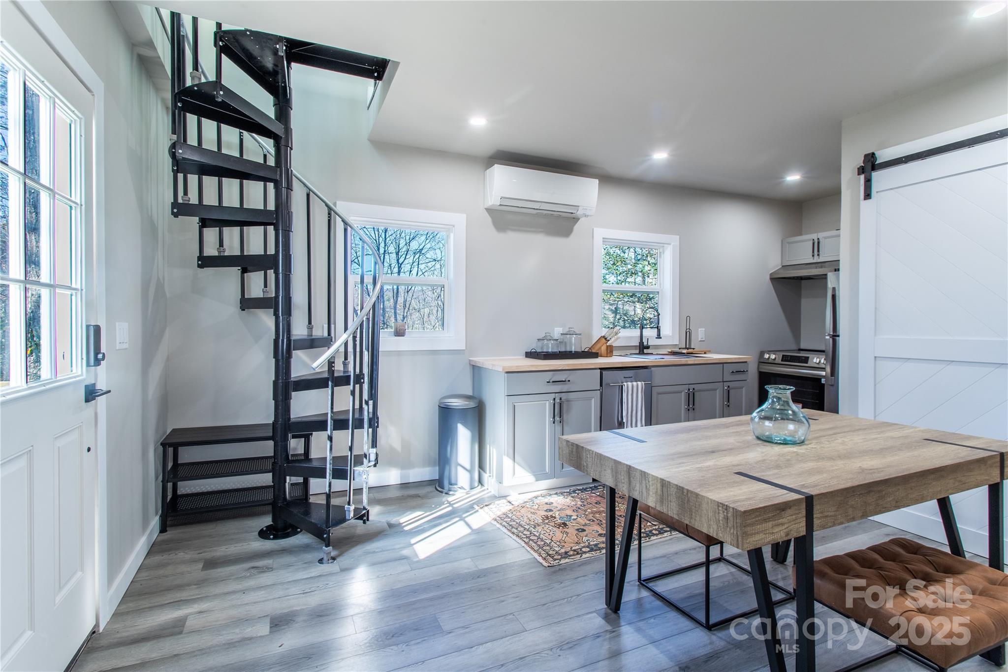 426-428 Weaver Creek Road Brevard, NC 28712 - Photo 7 of 48 a view of a dining room with furniture and wooden floor