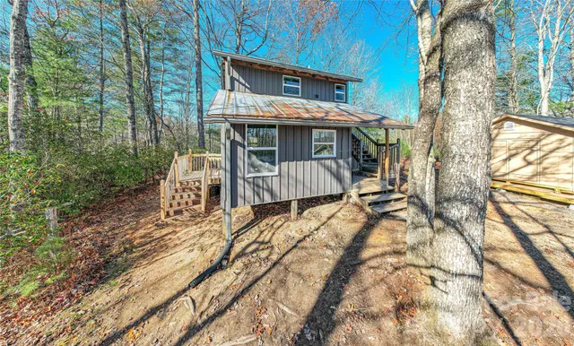 a view of a house with backyard porch and sitting area