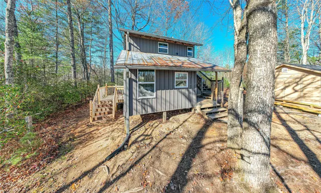 a view of a house with backyard porch and sitting area