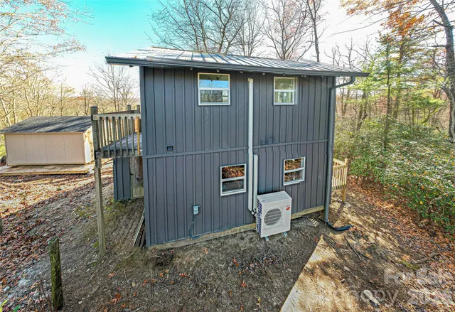 a view of backyard with outdoor seating and trees