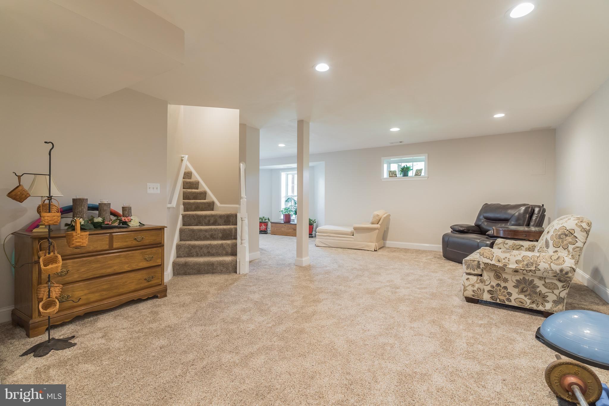 7420 Flint Hill Road Owings, MD 20736 - Photo 23 of 30 a living room with furniture and a flat screen tv