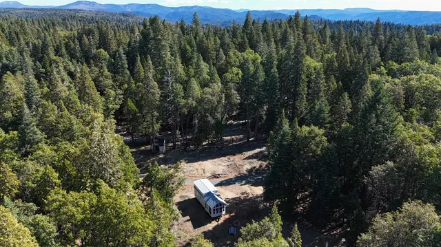 an aerial view of a house with lots of trees