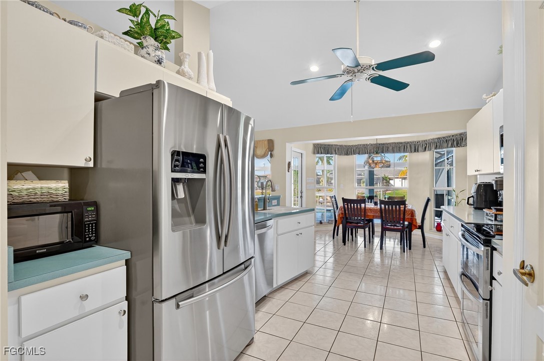 4306 Southwest 3rd Avenue Cape Coral, FL 33914 - Photo 14 of 50 a kitchen with granite countertop a refrigerator and a stove top oven
