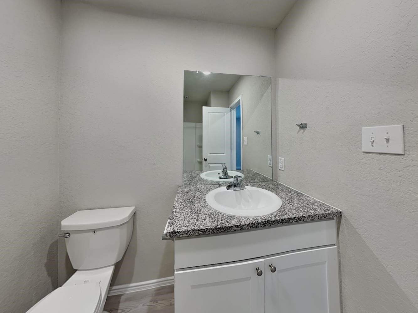 4322 Rapids Way San Antonio, TX 78223 - Photo 16 of 17 a bathroom with a granite countertop toilet sink and mirror