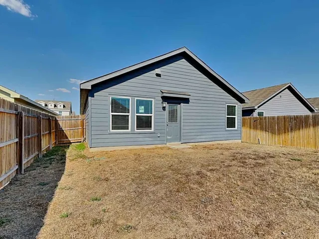 a house with trees in the background
