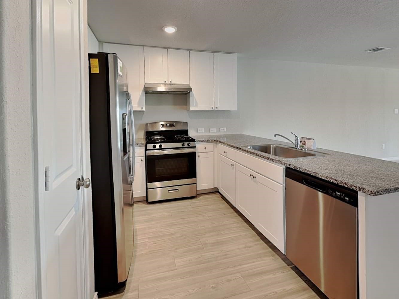 4322 Rapids Way San Antonio, TX 78223 - Photo 5 of 17 a kitchen with a sink stove and refrigerator