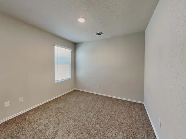 an empty room with a empty space and window