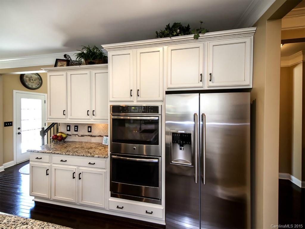 930 Solandra Way Tega Cay, SC 29708 - Photo 11 of 24 a kitchen with white cabinets and stainless steel appliances