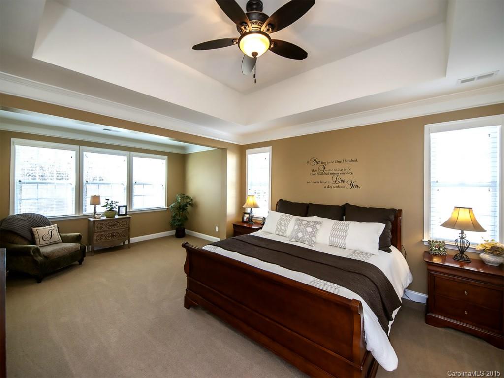 930 Solandra Way Tega Cay, SC 29708 - Photo 14 of 24 a bedroom with a bed and a couch next to a window