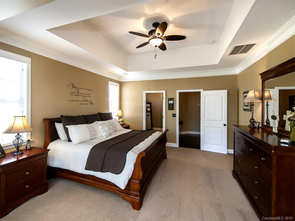 930 Solandra Way Tega Cay, SC 29708 - Photo 15 of 24 a spacious bedroom with a bed and a chandelier