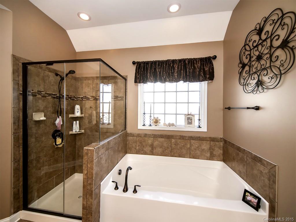 930 Solandra Way Tega Cay, SC 29708 - Photo 18 of 24 a bathroom with a bathtub and shower