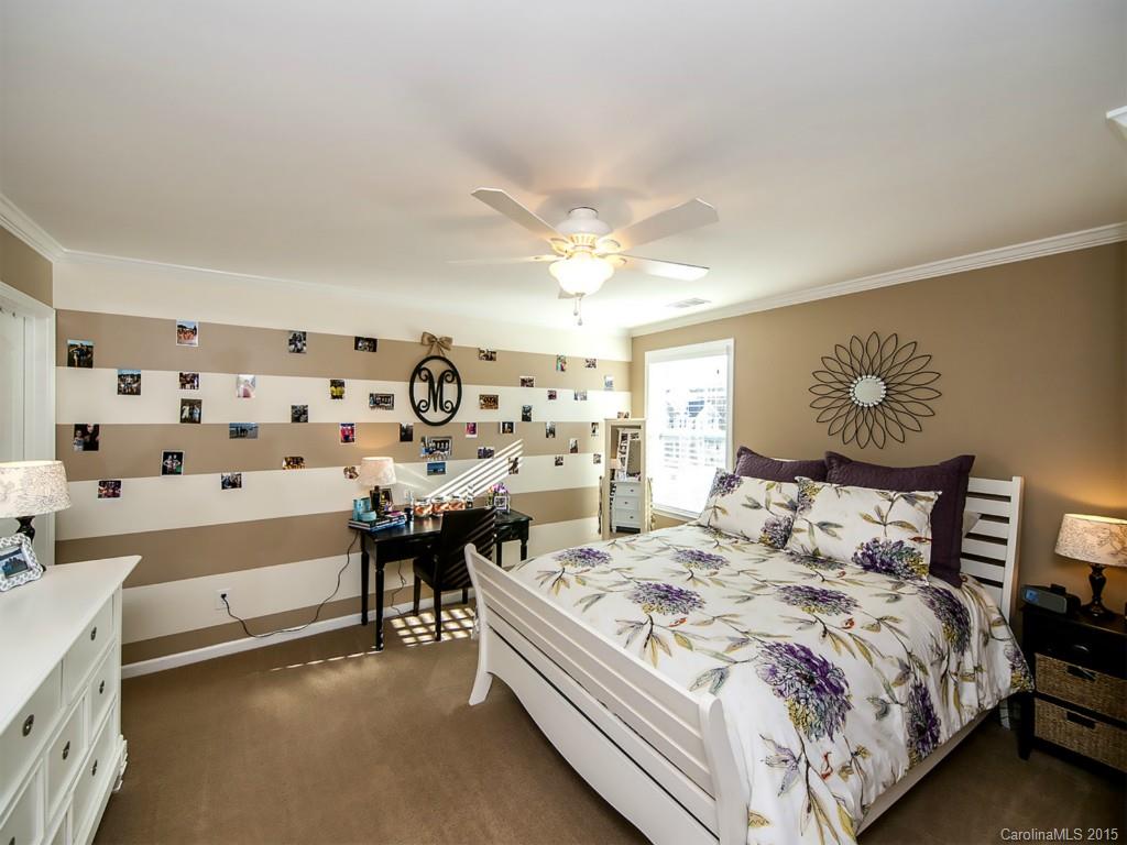 930 Solandra Way Tega Cay, SC 29708 - Photo 20 of 24 a bedroom with a bed and a chandelier