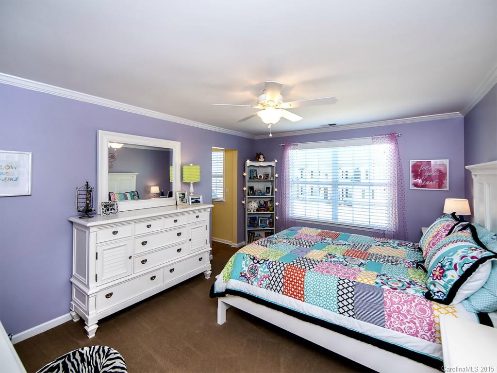 930 Solandra Way Tega Cay, SC 29708 - Photo 21 of 24 a bedroom with a bed and a dresser in it