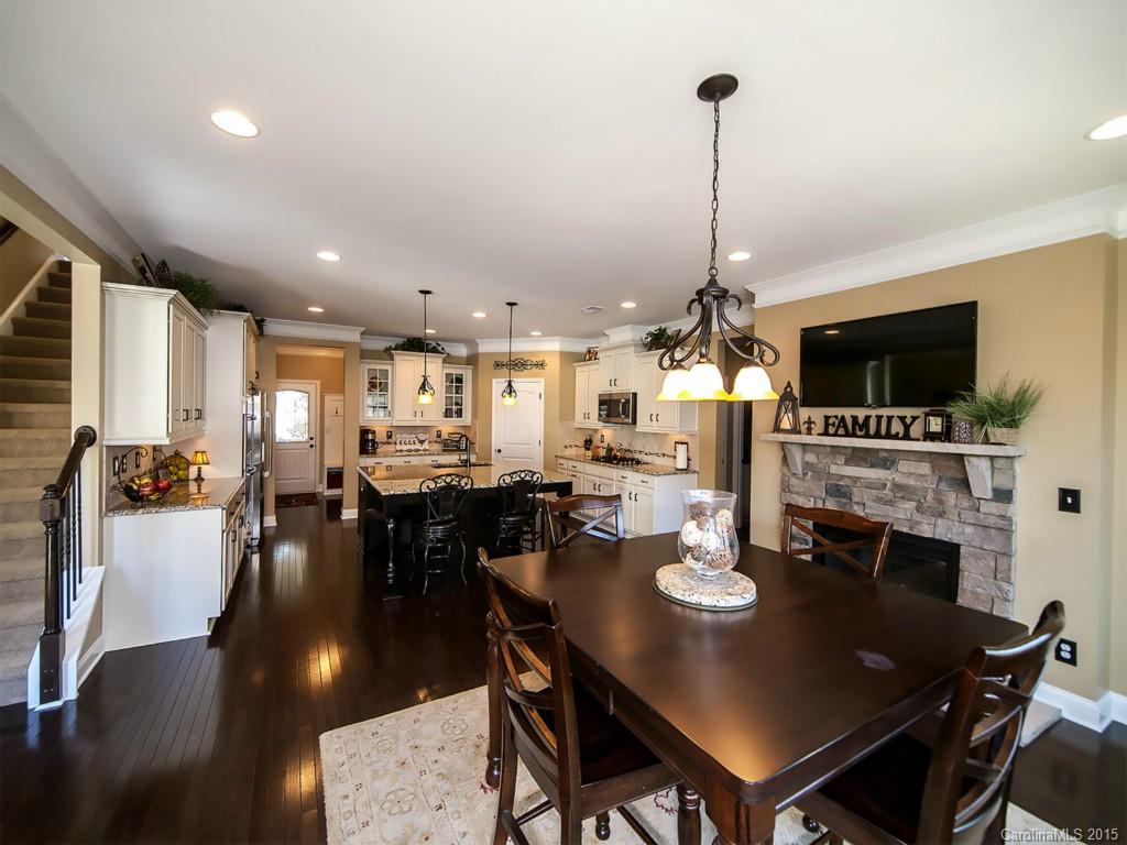 930 Solandra Way Tega Cay, SC 29708 - Photo 7 of 24 a dining room with furniture a chandelier and wooden floor