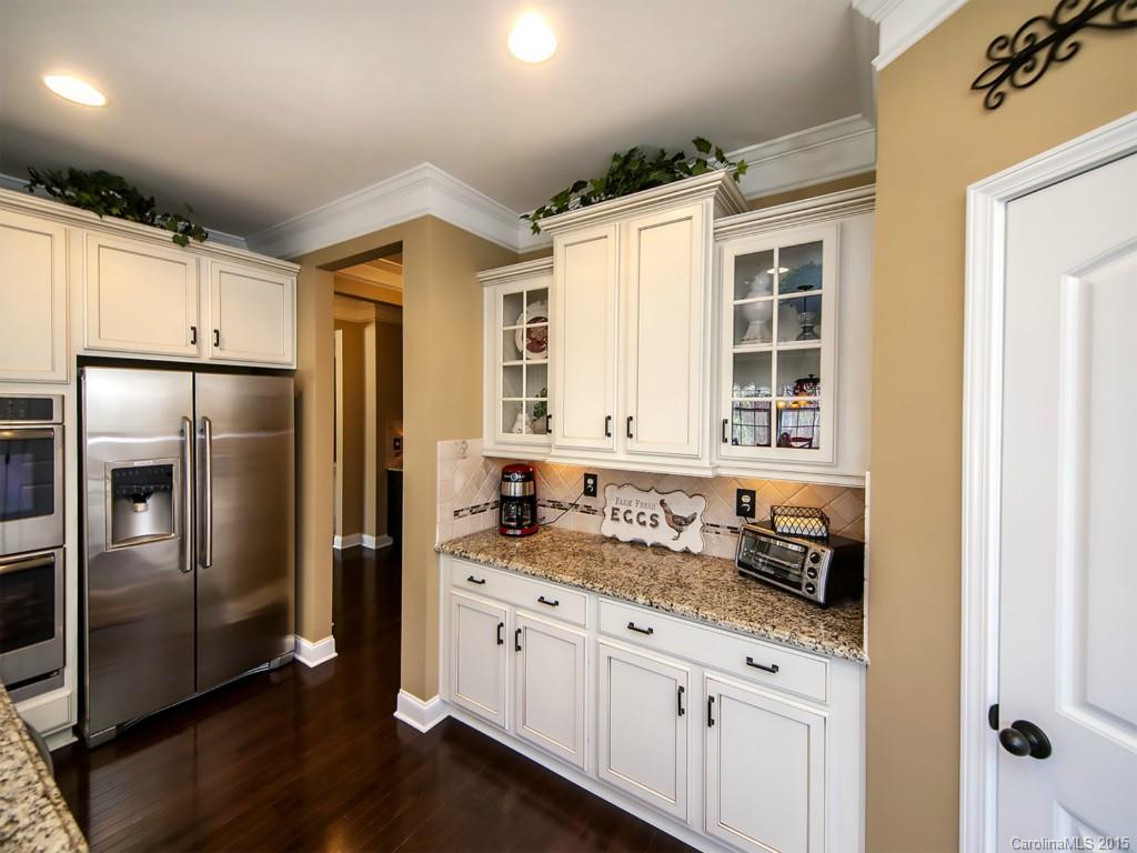 930 Solandra Way Tega Cay, SC 29708 - Photo 9 of 24 a kitchen with granite countertop a refrigerator and a sink