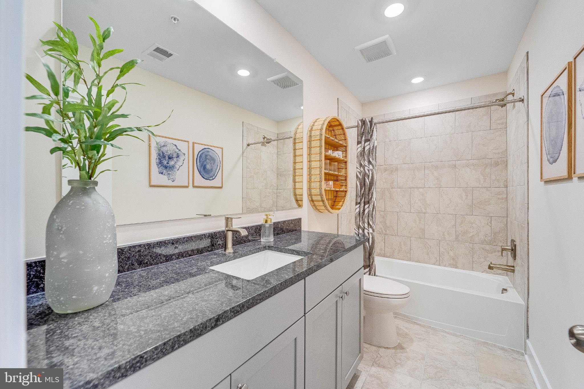 1723 Water Xing Road Baltimore, MD 21208 - Photo 17 of 21 a bathroom with a granite countertop sink a toilet and shower