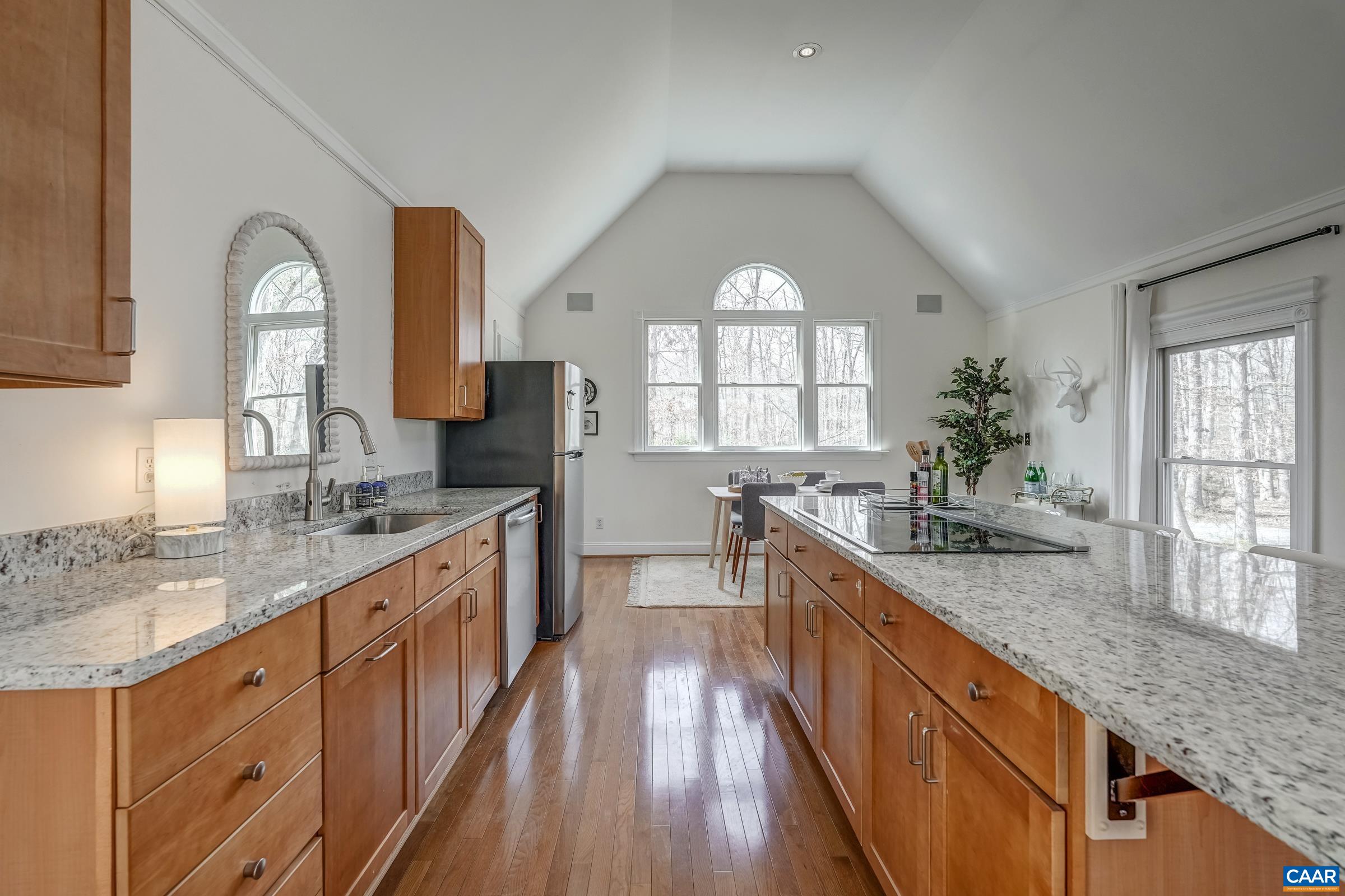 3595 Jumpers Ridge Road Keswick, VA 22947 - Photo 54 of 64 a large kitchen with granite countertop a large window a sink and stainless steel appliances