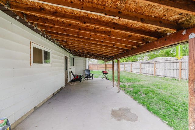 244 North 600 West Logan, UT 84321 - Photo 29 of 30 Expansive covered patio featuring a concrete surface, exposed wood beam ceiling, and white siding exterior