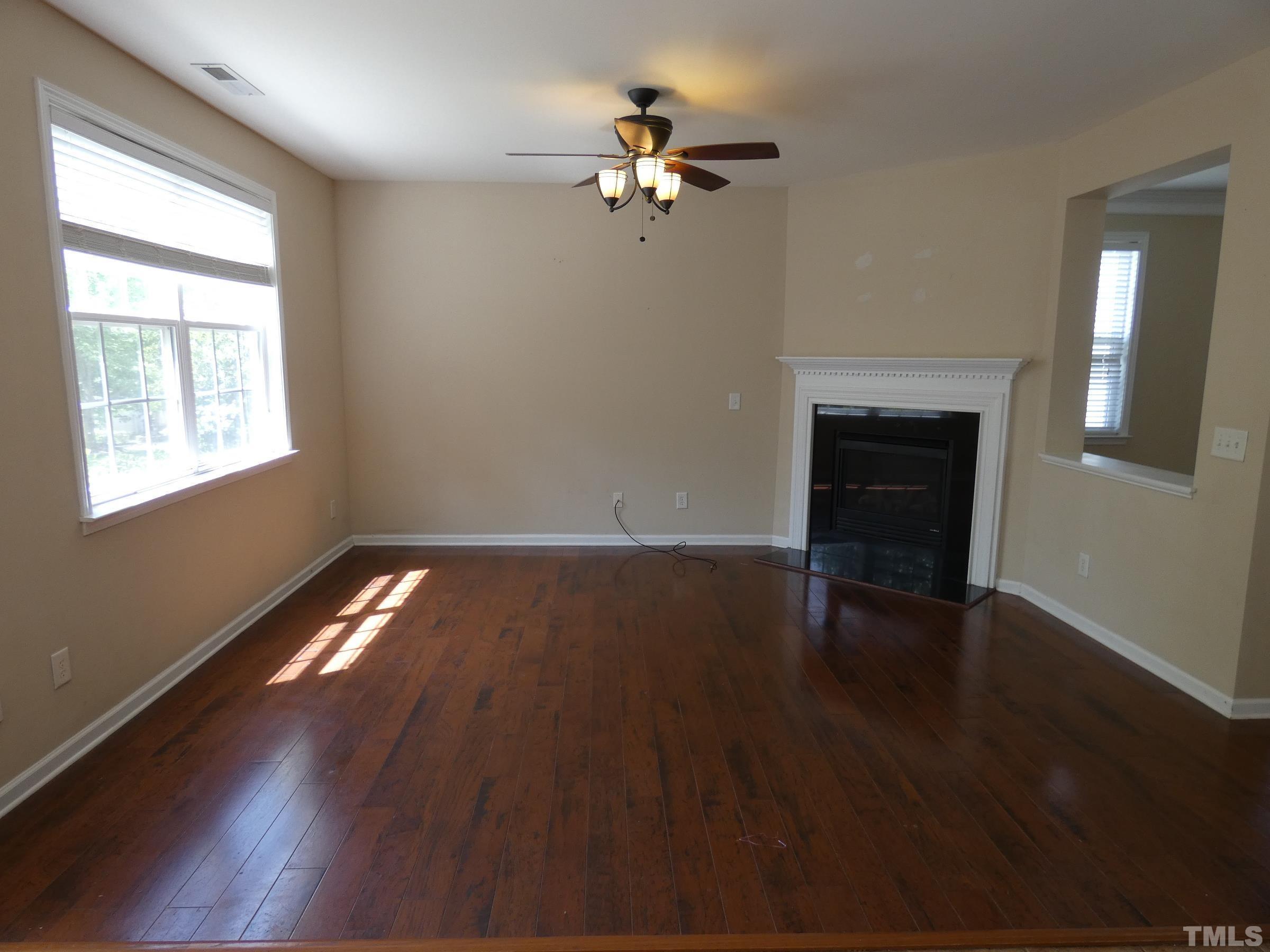704 Delta Downs Drive Cary, NC 27519 - Photo 5 of 22 wooden floor in an empty room with a window