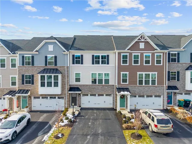 a car parked in front of a brick house