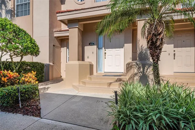 a living room with stainless steel appliances kitchen island granite countertop a refrigerator and a sink