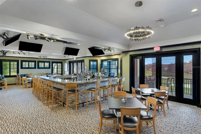 an aerial view of a house with a yard and lake view in back