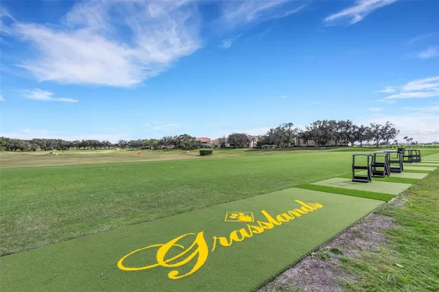 an aerial view of a residential houses with outdoor space swimming pool and green space