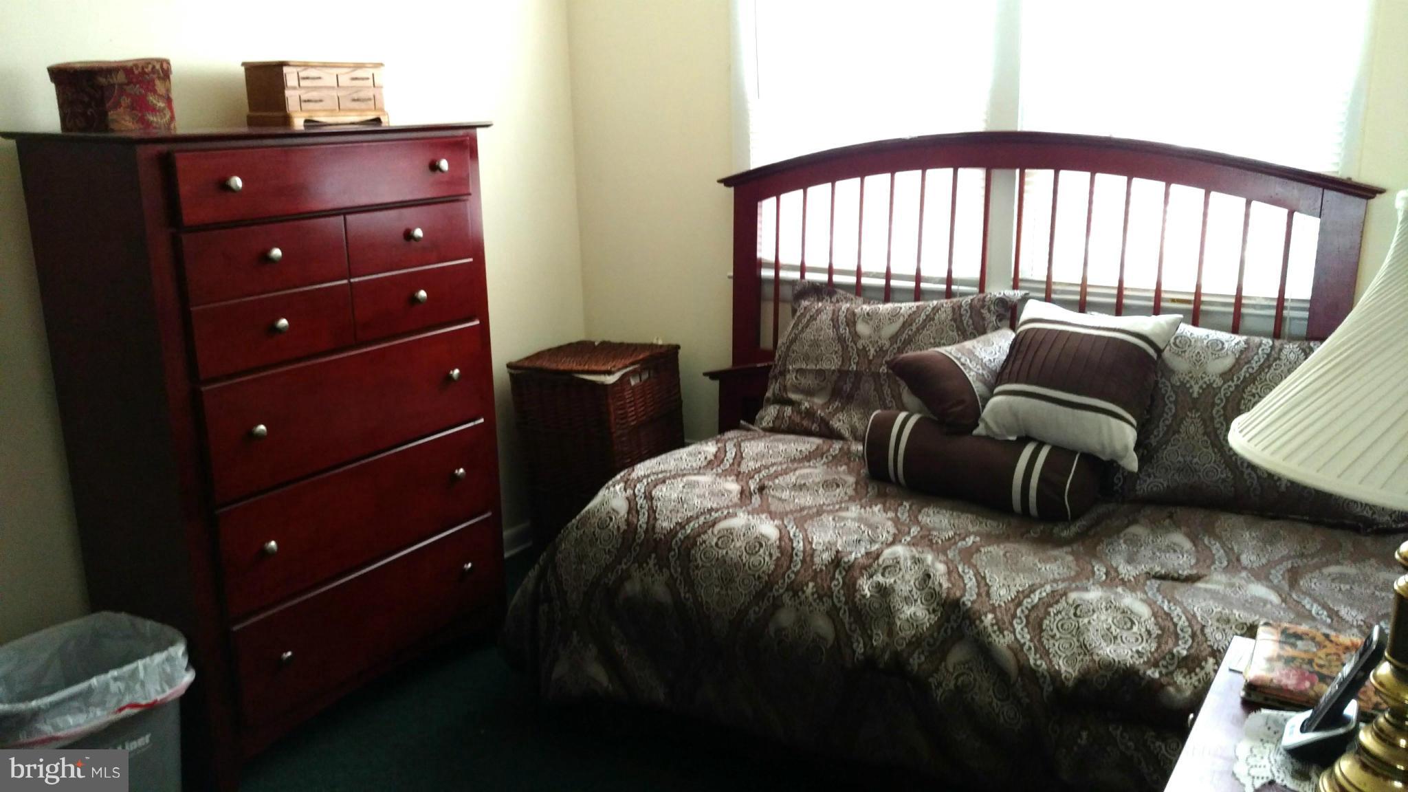 7136 Bexhill Road Baltimore, MD 21244 - Photo 12 of 27 a bedroom with a bed and a mirror