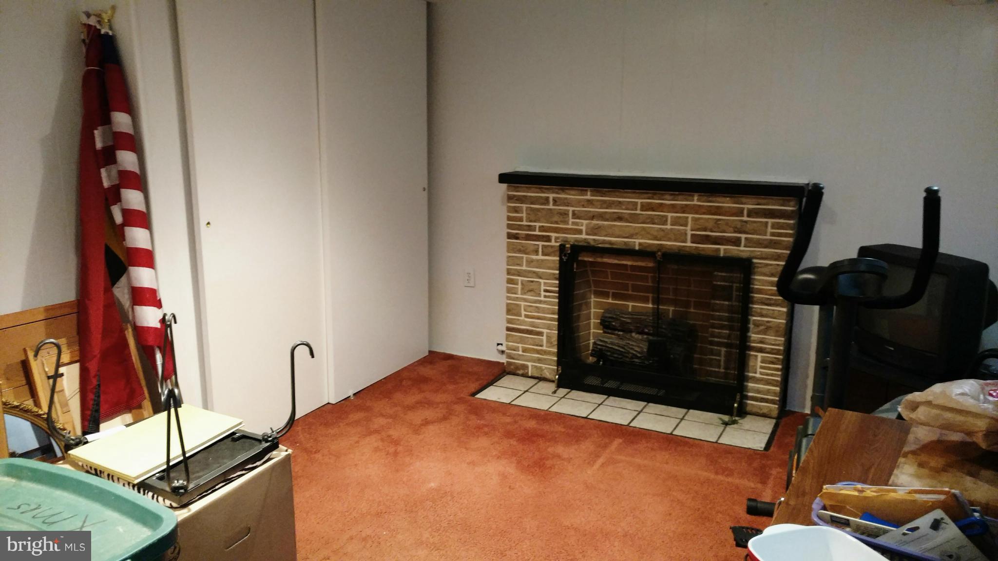7136 Bexhill Road Baltimore, MD 21244 - Photo 19 of 27 a bedroom with a bed and a fireplace